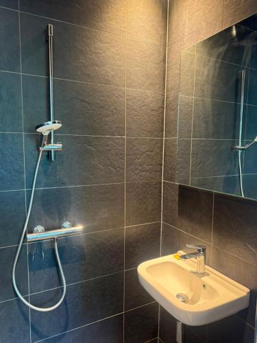 a bathroom with a sink and a shower at Modern Design Apartment with Balcon in Nijmegen