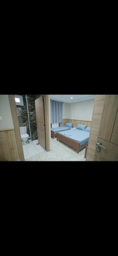 two pictures of a bedroom with a bed and a bathroom at مرقد الاخلاص in Fort de lʼEau