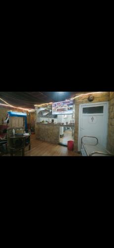 a room with a table and chairs and a door at مرقد الاخلاص in Fort de lʼEau