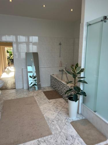 a bathroom with a tub and a sink and a mirror at Conscious Stay - Mindful Living in Berlin