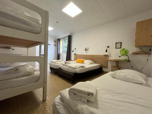 a room with two bunk beds and a desk at HOSTEL Les Bois Verts - Les Herbiers in Les Herbiers