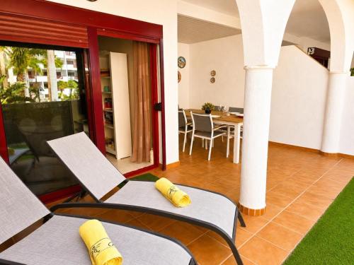 a living room with two chairs and a table at Oasis Palm Mar by HelloApartments in Palm-Mar