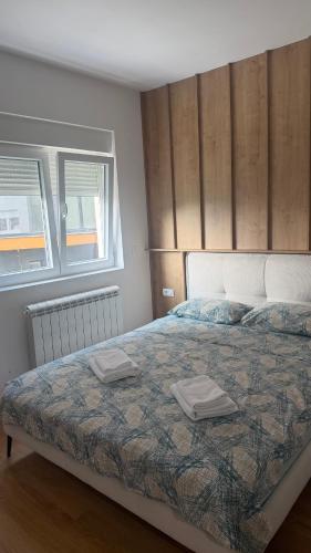 a bedroom with a bed with two towels on it at North & South Escape Kolašin in Kolašin