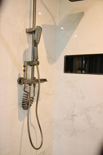 a shower with a blow dryer in a bathroom at Kumnandi Modern Suite in Beacon Bay