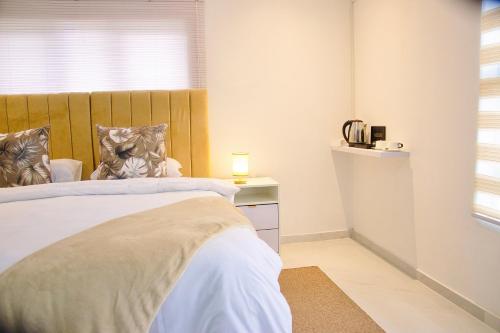 a bedroom with two beds and a window at Kumnandi Modern Suite in Beacon Bay