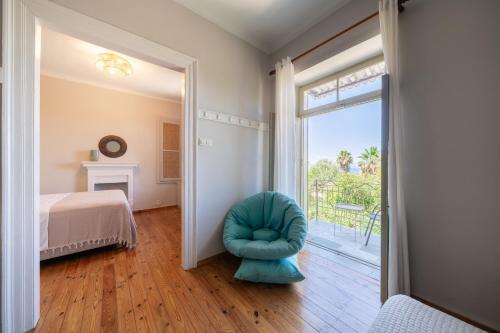 a bedroom with a blue ottoman in front of a door at Meraki Villa Pelion in Kalamos
