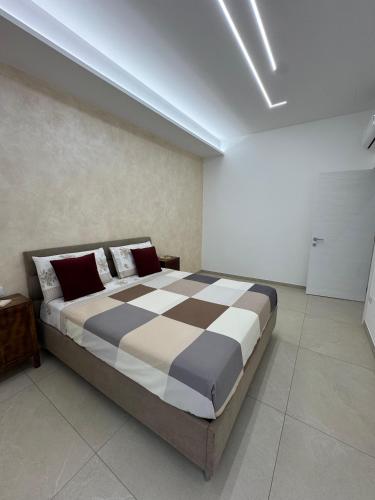 a bedroom with a large bed in a room at Casa Vittoria - Moderno bilocale a pochi passi dal mare in Galatone