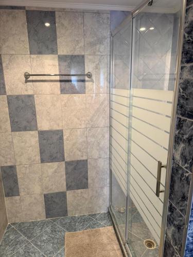 a shower with a glass door in a bathroom at Руми in Velingrad