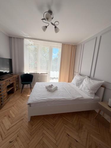 a bedroom with a bed and a ceiling fan at Apartament centrum in Białystok