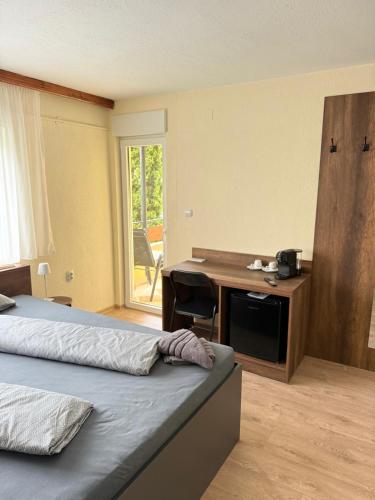 a bedroom with a desk and a bed and a deskictericter at Руми in Velingrad
