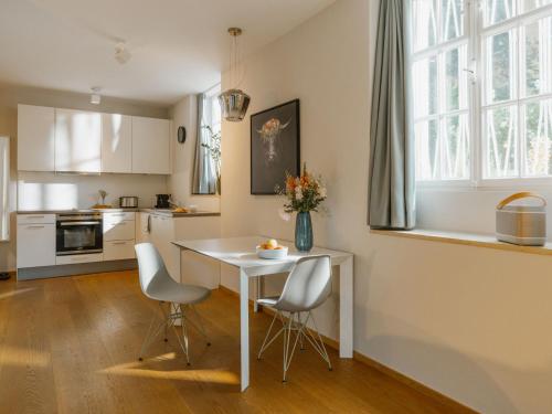 a kitchen with a white table and two chairs at Boutique Apartments Freiburg - Elsa in Freiburg im Breisgau