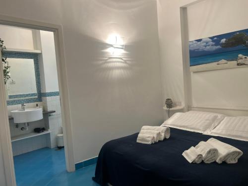 a bedroom with a bed with two towels on it at Piazzetta Sweet Home in Capri