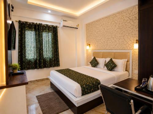 a hotel room with a bed and a desk at Hotel Regal Delight Star Taj - Best Rated Area #hygienic and Affordable Rooms, Check in Guarantee,Near Taj mahal in Agra