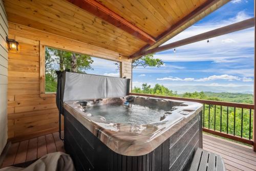 a hot tub on the deck of a cabin at Viewtopia in Beech Mountain