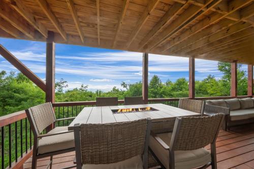 a patio with a table and chairs on a deck at Viewtopia in Beech Mountain