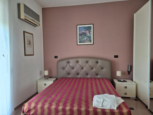 a bedroom with a bed with a red bedspread at Casa 2019 in Matera