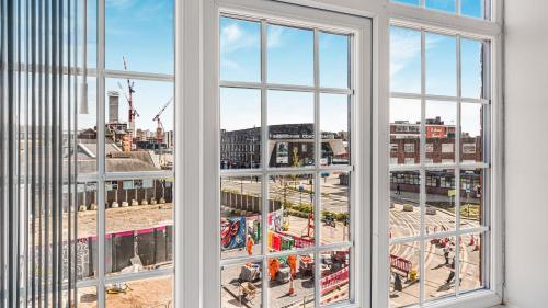 an open window with a view of a city at Birmingham Central Luxury Suites in Birmingham