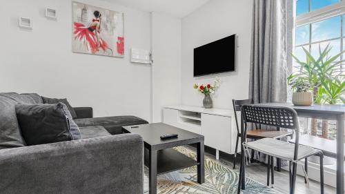 a living room with a couch and a table at Birmingham Central Luxury Suites in Birmingham