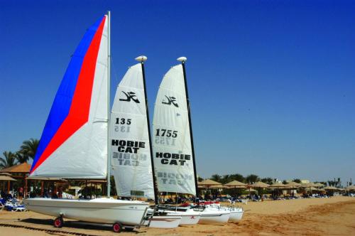a group of sailboats sitting on the beach at Stella Golf Hotel in Ain Sokhna