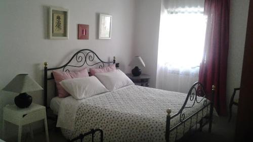 a bedroom with a bed with pink and white pillows at Casa Fattorini in Baceno