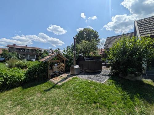 a backyard with a gazebo in the grass at Kierunek Puszcza 2 Apartamenty - Balia, Sauna, Grota solna - max 14 osob in Narewka