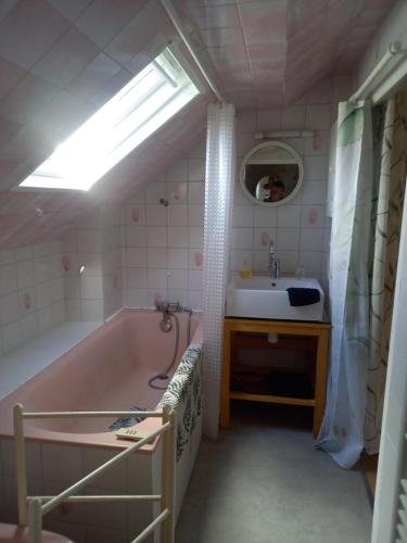 a bathroom with a bath tub and a sink at Clos Le Canoel in Elbeuf