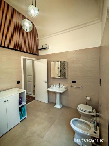 a bathroom with a toilet and a sink at Dimora dei Sicani in Aragona