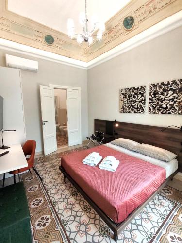a bedroom with a bed with two towels on it at Dimora dei Sicani in Aragona