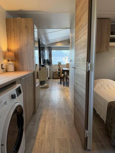 a small room with a bed and a washing machine at Tiny House in Jukkasjärvi in Jukkasjärvi
