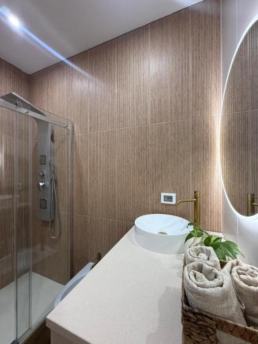 a bathroom with a toilet and a sink and a shower at Sikelia home in Giardini Naxos