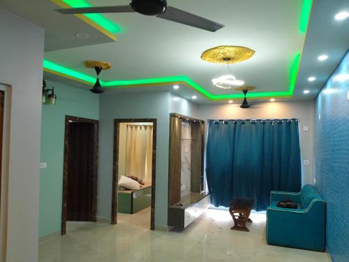 a living room with green lights on the ceiling at North Grande in kolkata