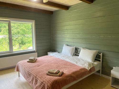 a bedroom with a bed with two towels on it at Кольорове життя in Mykulychyn