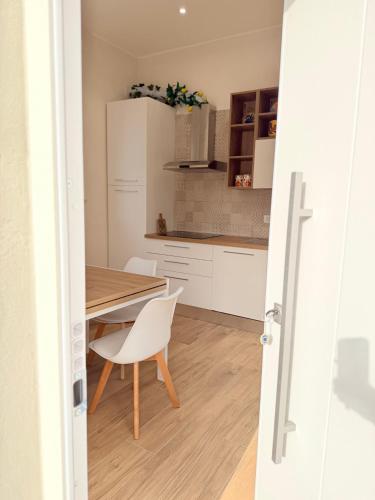 a kitchen with a wooden table and a dining room at Ramo D'oro Relax Apartments in Ariccia
