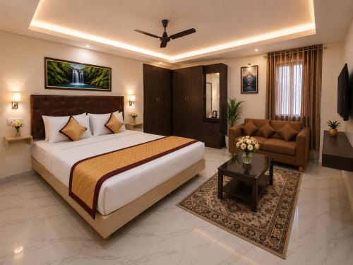 a bedroom with a large bed and a couch at Saravana Residency in Allinagaram