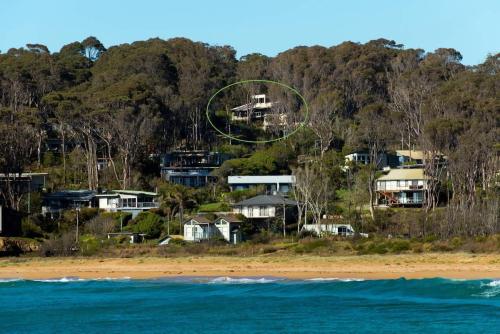 a group of houses on a hill next to the ocean at Seascapes at Rosedale in Tomakin