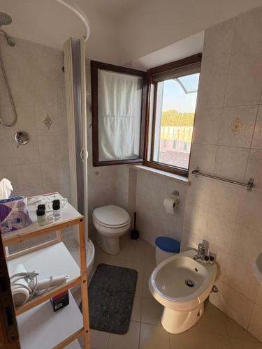 a bathroom with a sink and a toilet and a sink at Aperto Tuscany apartment in Torrenieri