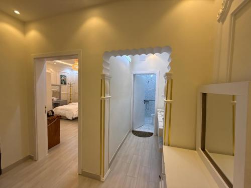 a hallway with a door leading to a bedroom at غرفة نوم 3 أسرّة مدخل خاص بدون صالة in Al Baha