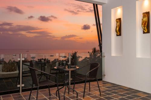 a dining room with a view of the ocean at The Plantation Koh Tao in Koh Tao