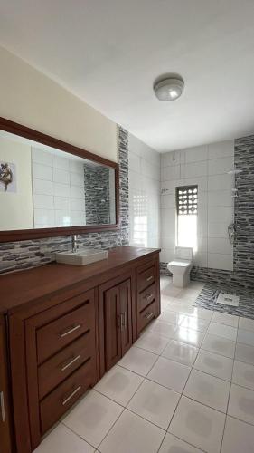 a large bathroom with a sink and a toilet at Villa REEL in Morondava