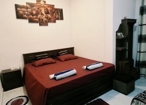 a bedroom with a bed with two pillows on it at Kandy Jungle Border in Kandy