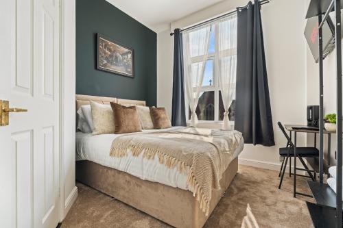 a bedroom with a bed and a window at The Churchill Hotel in Coventry