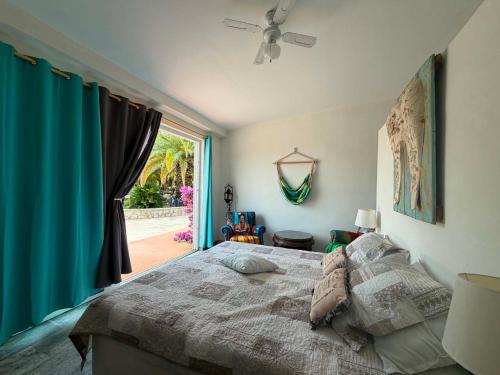a bedroom with a large bed and a window at Chambre d'hôtes in Ondara