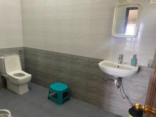 a bathroom with a toilet and a sink at Candy Ville Resorts in Coonoor