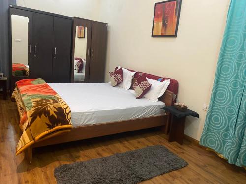 a bedroom with a bed with white sheets and pillows at Candy Ville Resorts in Coonoor