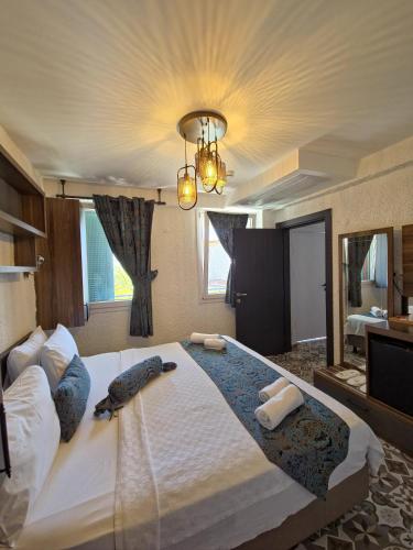 a bedroom with a large bed with a large mirror at Lotus City Sığacık in Seferihisar