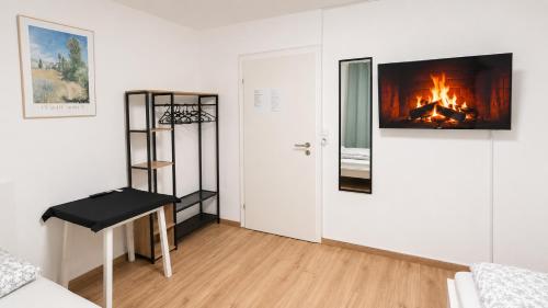 a living room with a fire in the wall at 92 City Rooms in Koblenz
