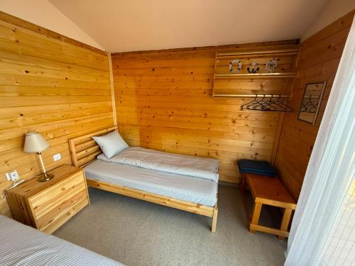 a small cabin with a bed and a table in it at Splav Astra Perućac in Perućac