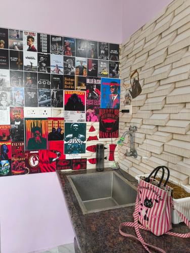 a kitchen with a sink and a wall with posters at Sunrise Strength Club in Villupuram