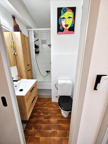a bathroom with a toilet and a sink at Modern Studio with Sea View and Balcony in Middelkerke