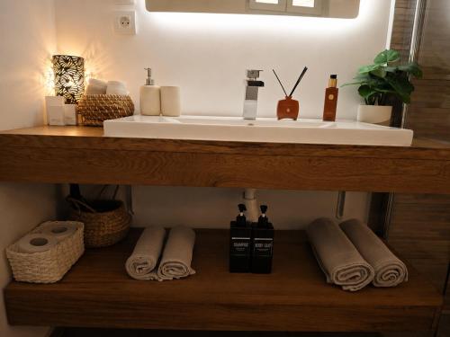 a bathroom with a sink and towels on a shelf at Home Dream/Erstein/3P/60m2 in Erstein